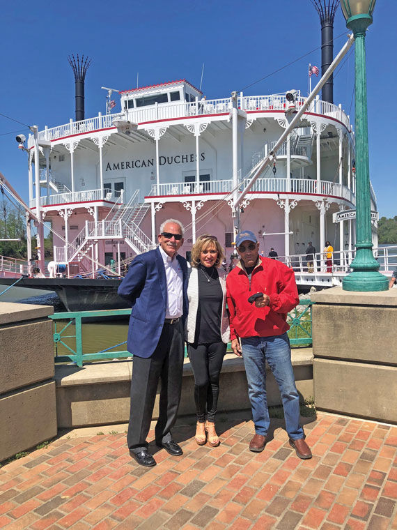 American Queen Voyages founder John Waggoner, left, and his wife, Claudette, with country musician Lee Greenwood, who hosts themed cruises with the river cruise company.