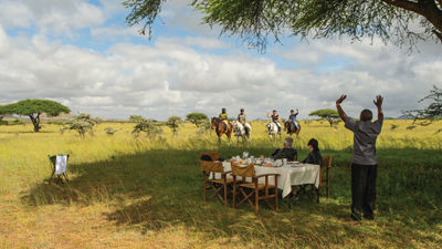 Guests at ol Donyo Lodge can ride horseback to a private breakfast in the bush.