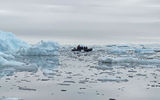 Also near the Fish Islands, a Zodiac motors slowly through a surreal scene of ice and flatwater.