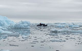 Also near the Fish Islands, a Zodiac motors slowly through a surreal scene of ice and flatwater.