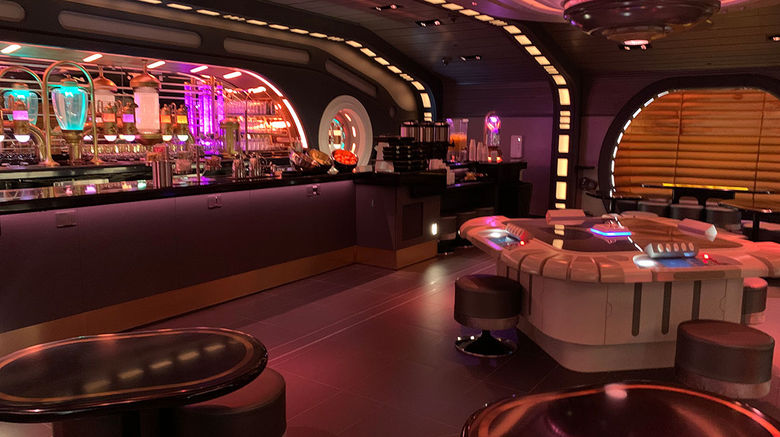The Sublight Lounge aboard the Halcyon, the flagship starcruiser of Chandrila Star Line, houses a sabacc table (right). Anyone could play when the table was free; there is also a tournament during guests' journey aboard the Halcyon. The hotel is set to open near Disney's Hollywood Studios, home to its Star Wars: Galaxy's Edge land, on March 1.