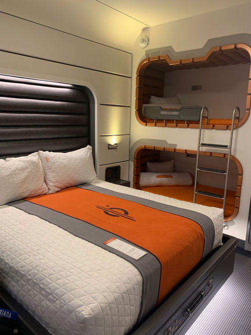 A queen-size bed and two bunks in the standard room. A queen-size bed and two bunks in the standard room.