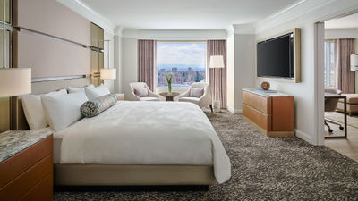 A one-bedroom suite. Guestrooms have subtle gold accents complemented by rich earth tones.