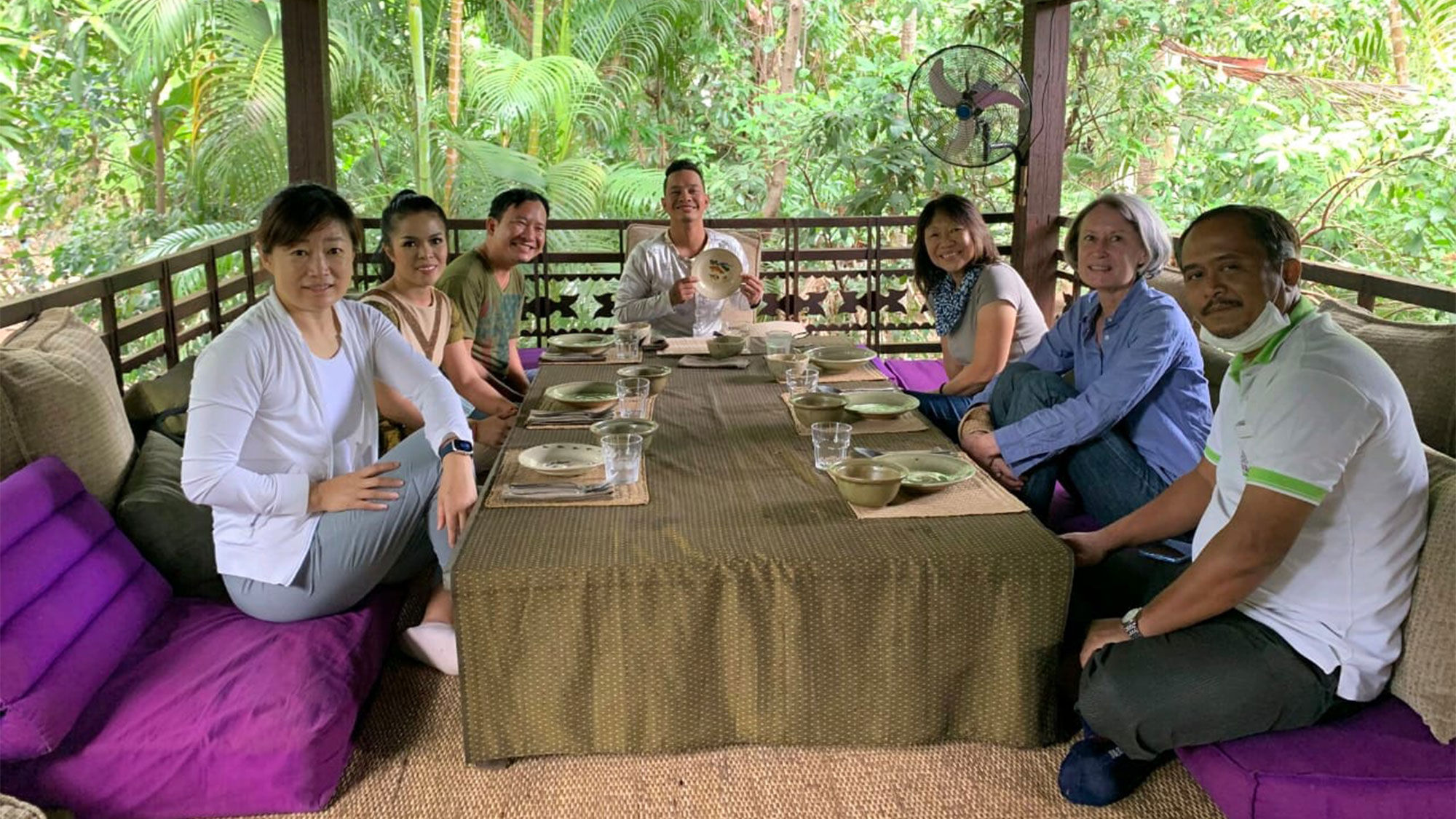 A home lunch with host Fabienne Luco (right row, second from left) and artists from Phare Cambodian Circus.