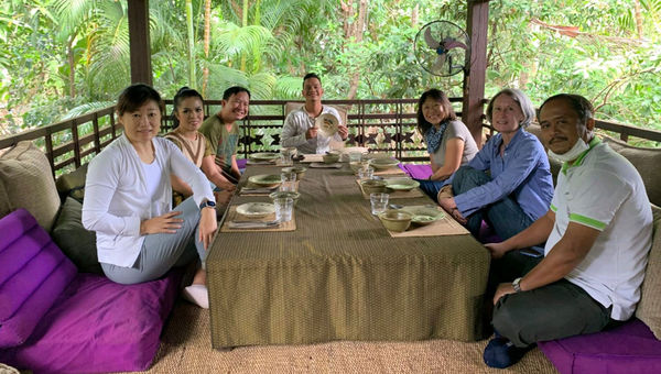 A home lunch with host Fabienne Luco (right row, second from left) and artists from Phare Cambodian Circus.