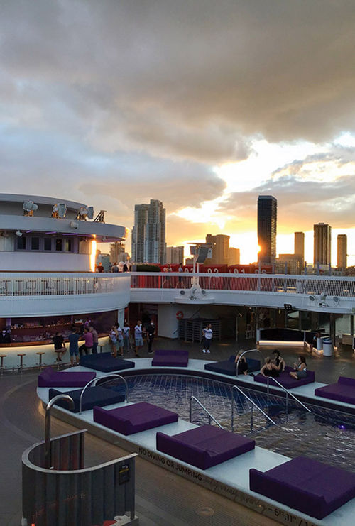 Sunset views of Miami from Deck 16 overlooking the Aquatic Club pool area. Sunset views of Miami from Deck 16 overlooking the Aquatic Club pool area.