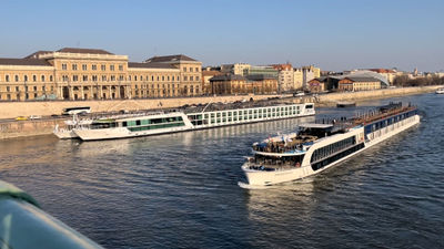 The Emerald Sun, the ship closest to shore, as seen from Liberty Bridge in Budapest during the first ASTA Global River Cruise Expo.