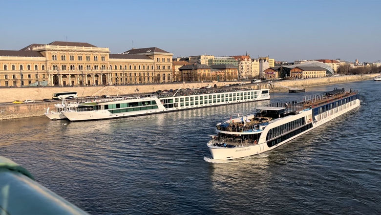 The Emerald Sun, the ship closest to shore, as seen from Liberty Bridge in Budapest during the first ASTA Global River Cruise Expo.