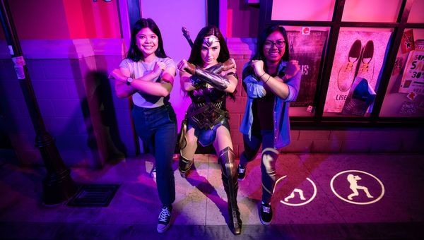 Guests having fun at the Justice League exhibit at Madame Tussauds Orlando.