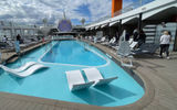 The pool deck aboard the Celebrity Beyond. The line claims it is the longest lap pool at sea at 25 meters