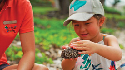 A child in the Four Seasons Academy checks out some local wildlife.