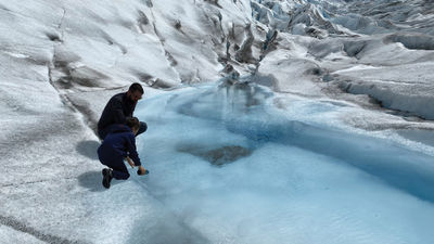 Drinking water from a glacier pool on an Alpine Alaska Air glacier-landing tour.
