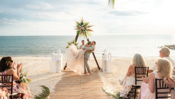 Kerri Brewster, owner of Escapes Unlimited and Sunlover Travel, kisses her husband at their wedding at the Sandals South Coast in Jamaica earlier this year.