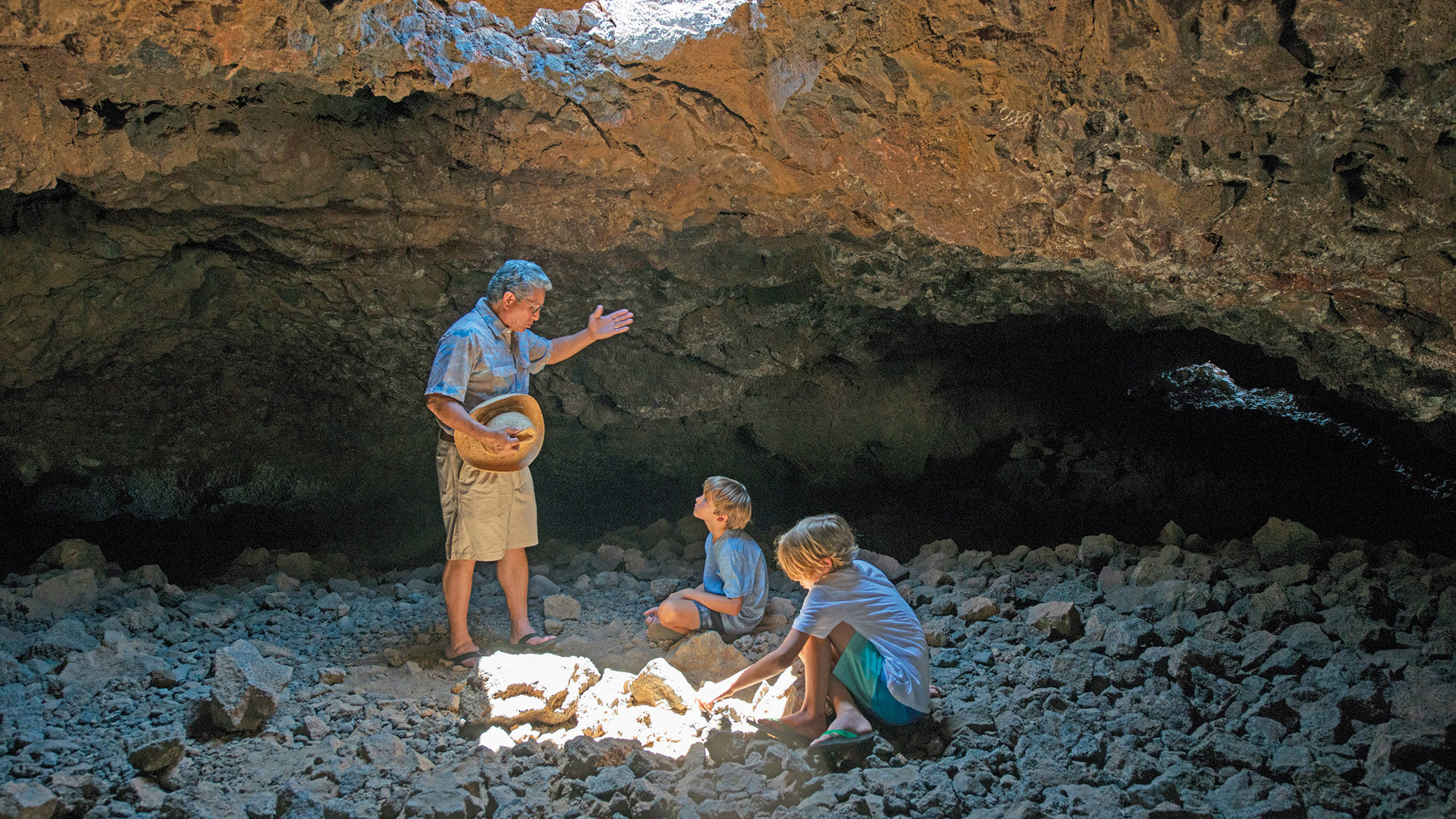 Children engage in a cave exploration as part of the programming at Mauna Lani, Auberge Resorts Collection.