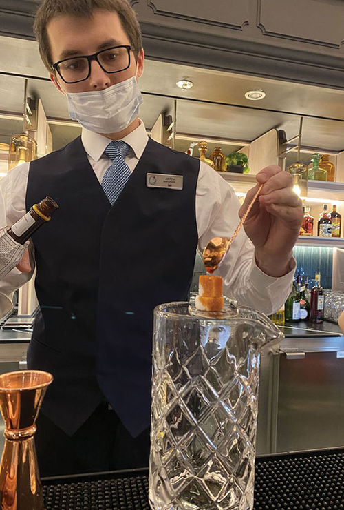 A bartender at Atlas bar creates a drink. A bartender at Atlas bar creates a drink.
