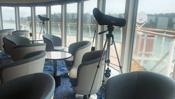 Spotting scopes and binoculars are situated around the Ocean Victory.