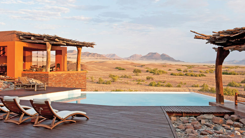 The Okahirongo Elephant Lodge includes amenities like an infinity pool and a traditional boma area, which plays host to evening fires and guest gatherings.