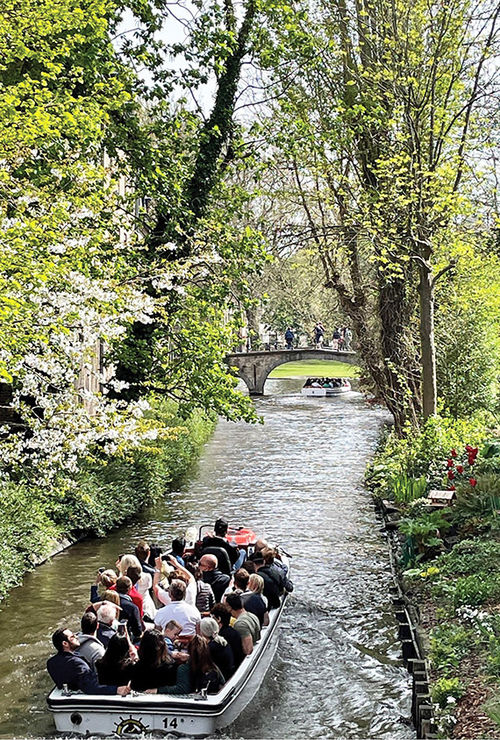 A crowded boat tour through one of the picturesque canals of Bruges. A crowded boat tour through one of the picturesque canals of Bruges.