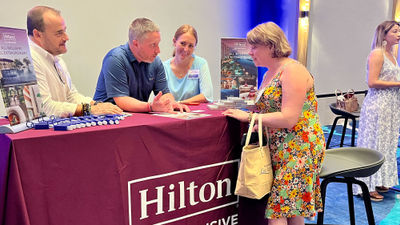 Hilton Tulum Riviera Maya representatives speaking with travel advisor Agnieszka Jones at the Pleasant Holidays Elite Experience retreat.