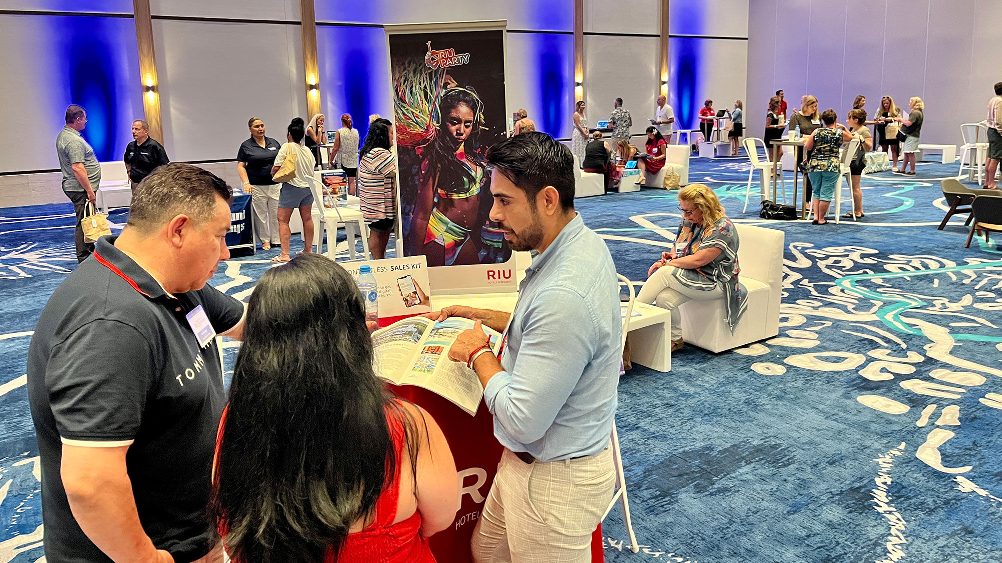 Jonathan Onofre (right), a business development manager for Riu Hotels & Resorts, speaks with travel advisors at the Pleasant Holidays Elite Experience retreat.