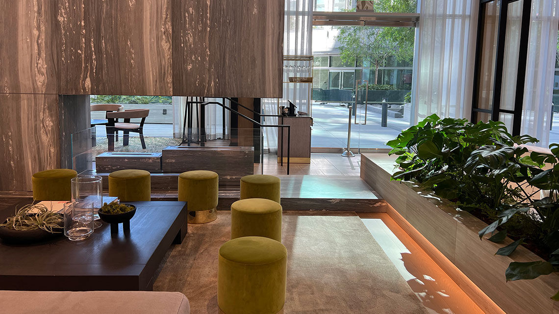 The lobby incorporates greenery, water features, marble and a fire pit.