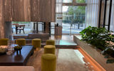 The lobby incorporates greenery, water features, marble and a fire pit.
