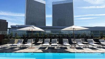 The Century Plaza Towers provide the backdrop for the rooftop pool at the Fairmont Century Plaza, a luxury hotel in Los Angeles.