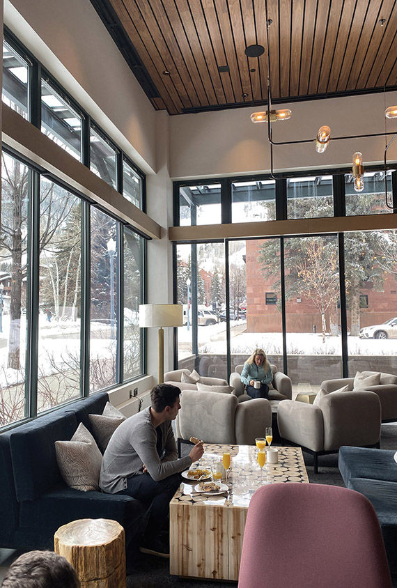 Guests enjoy the complimentary breakfast in the lobby at the Limelight Hotel Aspen.
