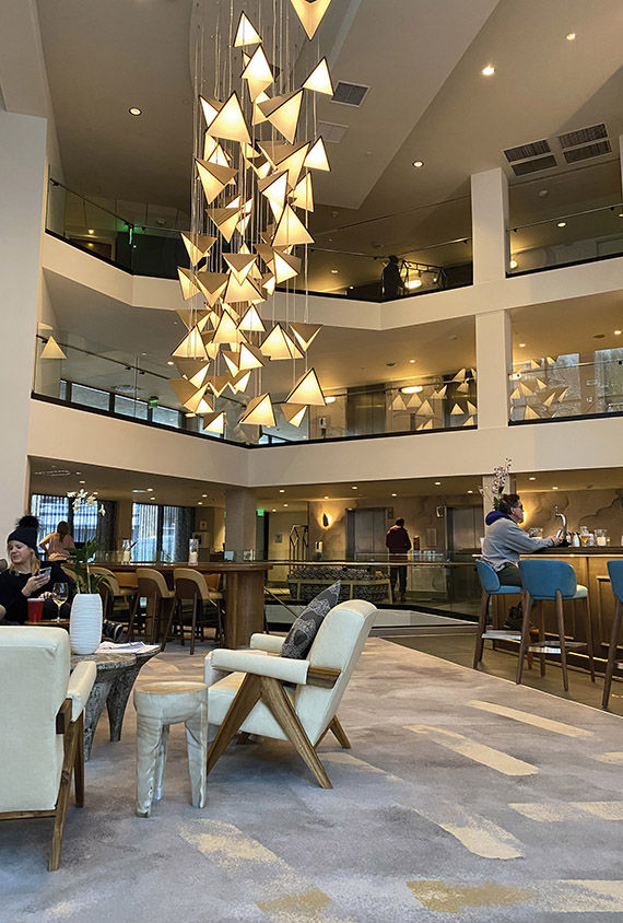 The lobby of the Viewline Resort Snowmass, Autograph Collection, with its three-story Viewline Lobby Bar.