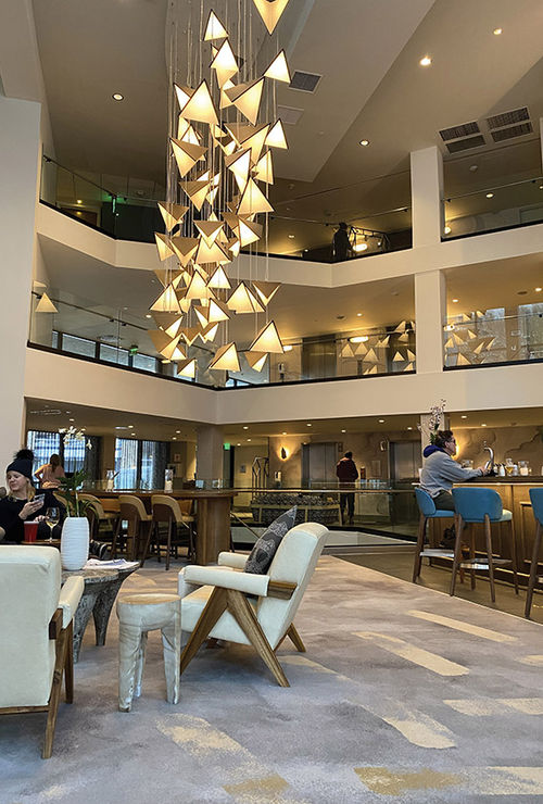 The lobby of the Viewline Resort Snowmass, Autograph Collection, with its three-story Viewline Lobby Bar.