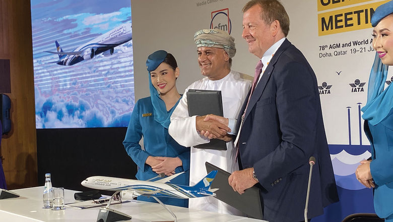 Oman Air CEO Eng Abdulaziz Al Raisi and Oneworld CEO Rob Gurney shake hands at a signing ceremony.