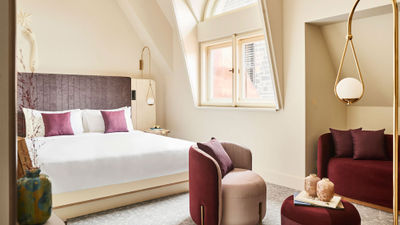 A top-floor room in the Andaz Prague, where ceiling lines imitate an attic.