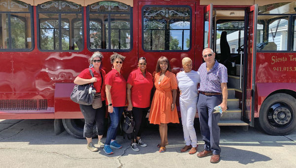 Stephanie Jones (third from right) and members of the Black Cultural Heritage Tours team meet with Newtown Alive Trolley Tours staff in Sarasota, Fla.