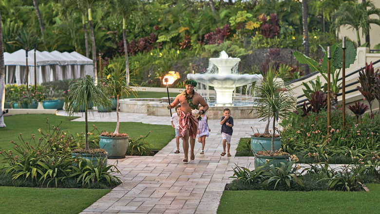 Children participate in a torch-lighting ceremony at the Four Seasons Resort Maui at Wailea.