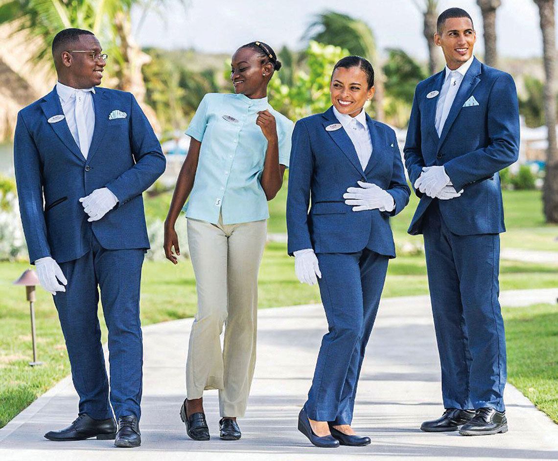 Sandals staff models new uniforms.