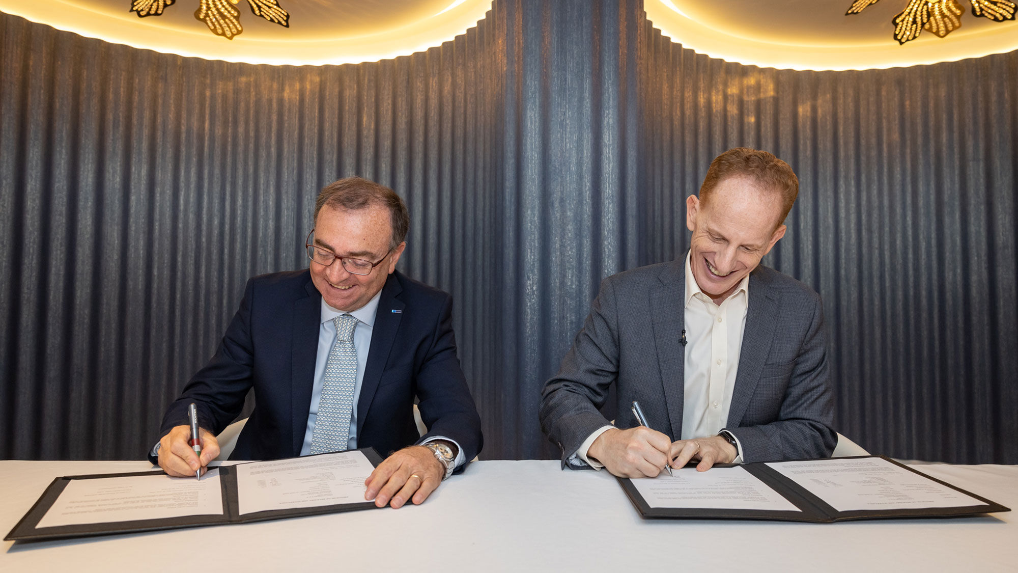 Luigi Matarazzo (left), general manager of Fincantieri's Merchant Ships division, and Norwegian Cruise Line CEO Harry Sommer sign off on the Norwegian Prima delivery.