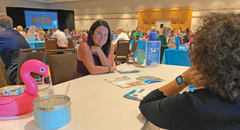 Jennifer Kellum, owner of Neverland & Main Travel in Jacksonville, N.C., meets with a supplier at the GTM conference in Hollywood, Fla.