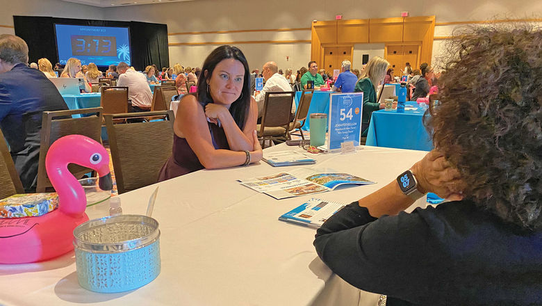 Jennifer Kellum, owner of Neverland & Main Travel in Jacksonville, N.C., meets with a supplier at the GTM conference in Hollywood, Fla.