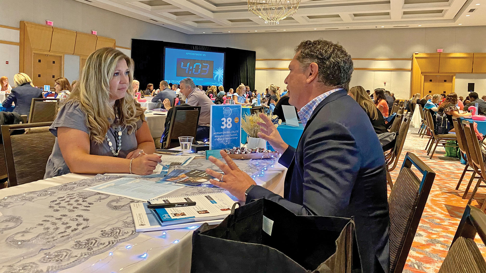 Morgan Graybill, owner of Morning Star Luxury Travel in Greenville, S.C., meets with a supplier at the Global Travel Marketplace in Hollywood, Fla.