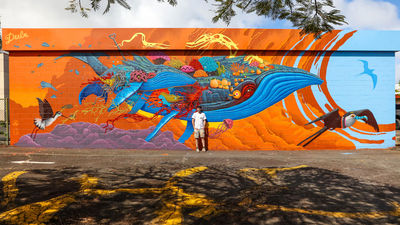 Artist Antonio Donat with the mural “Legacy” in Wailuku. Since 2019, 47 pieces of public art, including 18 murals, have been erected in the Maui town.
