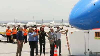 Dignitaries celebrate the arrival of the first commercial flight at San Bernardino Airport.