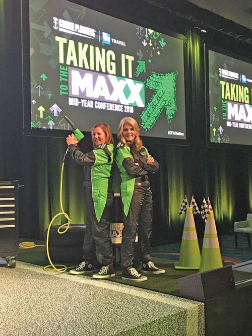 Vicky Garcia (left) and Michelle Fee on stage at a Cruise Planners event in 2018.