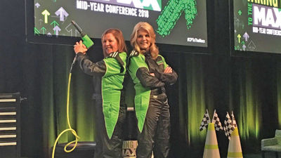 Vicky Garcia (left) and Michelle Fee on stage at a Cruise Planners event in 2018.
