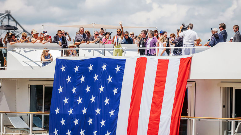 The American Symphony's godmother, Miss USA 2020 pageant winner Asya Branch, waves to the crowd in Natchez at the ship's christening ceremony.
