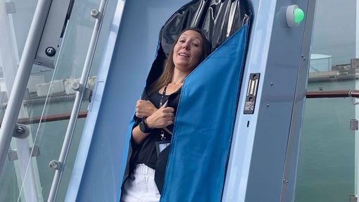 Cruise editor Andrea Zelinski, bundled into a sleeping bag-like liner, moments before dropping into the Drop slide on the Norwegian Prima