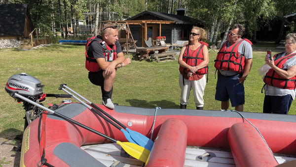 Tour guide Timo Lankanen preparing guests for a rafting excursion on the Kymi River in Finland.