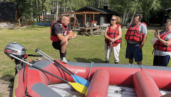 Tour guide Timo Lankanen preparing guests for a rafting excursion on the Kymi River in Finland.