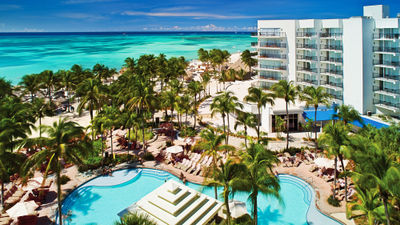 The pool area and palm-lined beach at the Aruba Marriott Resort & Stellaris Casino.