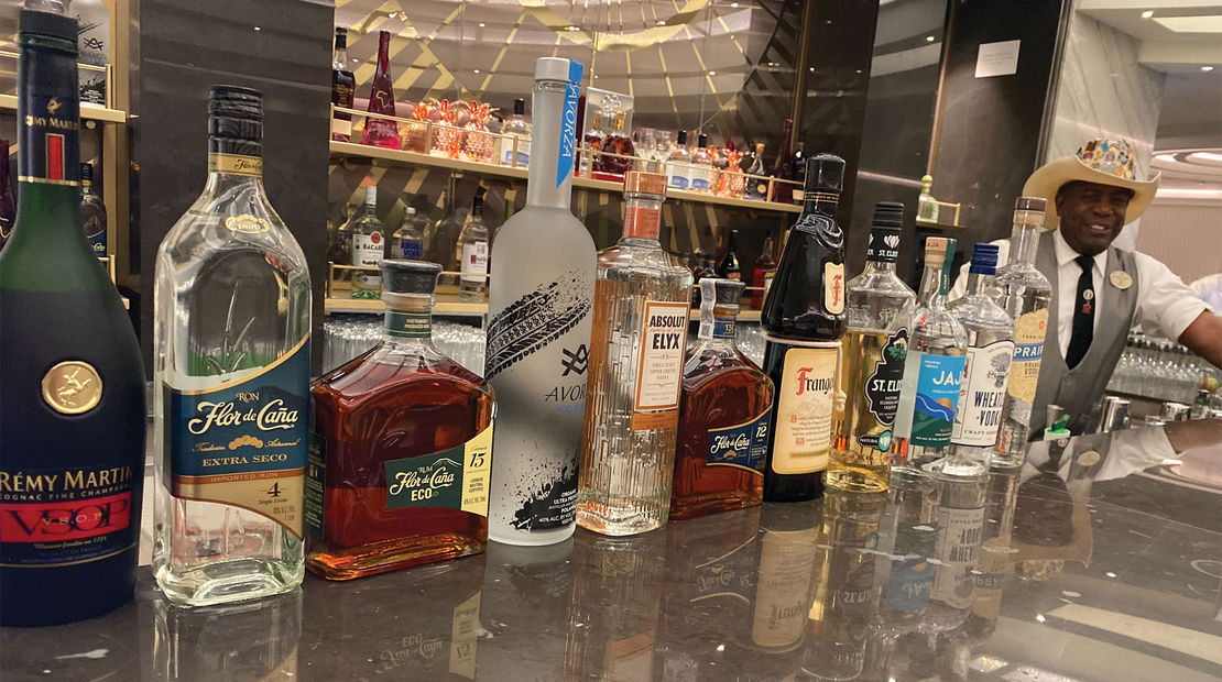 Bartender Clarence Bennett displays liquors at the Metropolitan Bar, many of which are touted as sustainable alcohol brands.