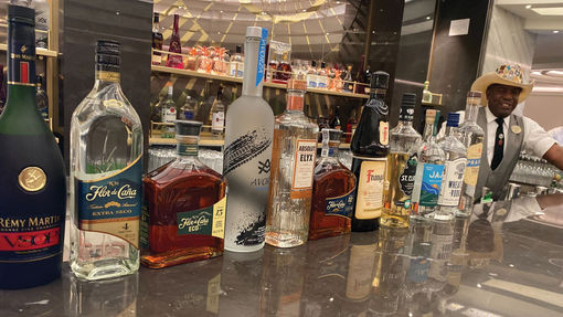 Bartender Clarence Bennett displays liquors at the Metropolitan Bar, many of which are touted as sustainable alcohol brands.